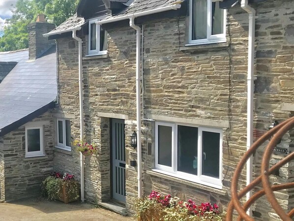Front of Elmtree Cottage with containers of floweers