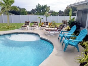 SALTWATER PRIVATE POOL WITH SUNSHELF. LOUNGE CHAIRS AND YARD GAMES