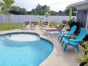SALTWATER PRIVATE POOL WITH SUNSHELF. LOUNGE CHAIRS AND YARD GAMES