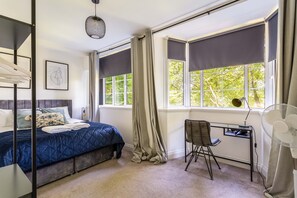 Bedroom with double windows and work / vanity area