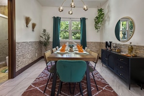 A bathroom is next to the dining area