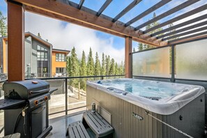 Private patio with a BBQ and a hot tub.