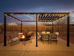 Outdoor space with a fire pit, grill & dining area!