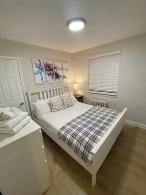 First Bedroom with queen bed, dresser and closet.