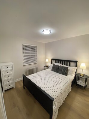 Second bedroom with queen bed, dresser and closet.