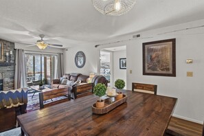 Living and dining area with access to back deck