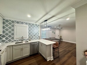 Ample fully stocked kitchen with refrigerator, range, microwave and dishwasher.