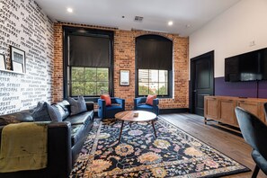 Relax in the living area with a smart TV, stylish seating, and a sleeper sofa for extra guests. Perfect for families or group stays in New Orleans, this inviting space is ideal for movie nights or recharging after a day in the city.