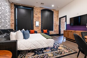 Relax in the living area with a smart TV, stylish seating, and a sleeper sofa for extra guests. Perfect for families or group stays in New Orleans, this inviting space is ideal for movie nights or recharging after a day in the city.