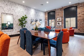 Enjoy meals together at your in-suite dining table with seating for your group. Whether it's takeout, delivery, or a home-cooked meal, this cozy dining area makes every stay at 888 Baronne feel like home in New Orleans.