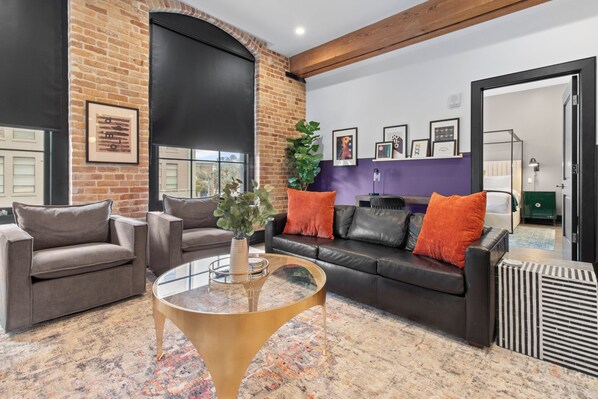 Relax in the living area with a smart TV, stylish seating and a sleeper sofa for extra guests. Perfect for families or group stays in New Orleans, this inviting space is ideal for movie nights or recharging after a day in the city.