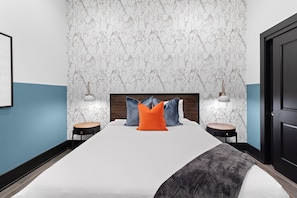 The second bedroom offers a cozy queen bed, dresser, smart TV, and soft linens. Great for families or friends traveling together, this room combines comfort and privacy in the heart of Downtown New Orleans.