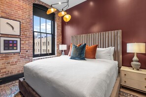 Retreat to the primary bedroom with a plush king bed, walk-in closet, blackout shades, and a smart TV. Designed for comfort and privacy, this suite is perfect for recharging after a day exploring New Orleans.