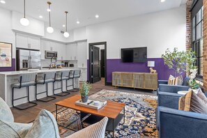 Relax in the living area with a smart TV, stylish seating, and a sleeper sofa for extra guests. Perfect for families or group stays in New Orleans, this inviting space is ideal for movie nights or recharging after a day in the city.