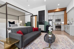 Relax in the studio living area with a smart TV, stylish seating, king-sized bed and a futon for extra guest. This inviting space is ideal for movie nights or recharging after a day in the city.