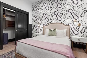 The second bedroom offers a cozy queen bed, dresser, smart TV, and soft linens. Great for families or friends traveling together, this room combines comfort and privacy in the heart of Downtown New Orleans.