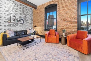 Relax in the living area with a smart TV, stylish seating, and a sleeper sofa for extra guests. Perfect for families or group stays in New Orleans, this inviting space is ideal for movie nights or recharging after a day in the city.