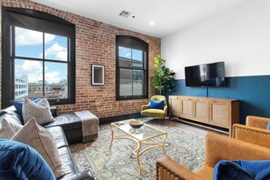 Relax in the living area with a smart TV, stylish seating, and a sleeper sofa for extra guests. Perfect for families or group stays in New Orleans, this inviting space is ideal for movie nights or recharging after a day in the city.