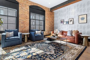 Relax in the living area with a smart TV, stylish seating, and a sleeper sofa for extra guests. Perfect for families or group stays in New Orleans, this inviting space is ideal for movie nights or recharging after a day in the city.