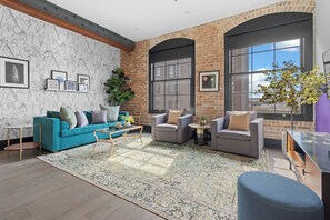Relax in the living area with a smart TV, stylish seating, and a sleeper sofa for extra guests. Perfect for families or group stays in New Orleans, this inviting space is ideal for movie nights or recharging after a day in the city.