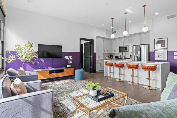 Relax in the living area with a smart TV, stylish seating, and a sleeper sofa for extra guests. Perfect for families or group stays in New Orleans, this inviting space is ideal for movie nights or recharging after a day in the city.