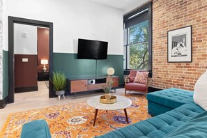 Relax in the living area with a smart TV, stylish seating, and a sleeper sofa for extra guests. Perfect for families or group stays in New Orleans, this inviting space is ideal for movie nights or recharging after a day in the city.