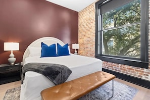 Retreat to the primary bedroom with a plush king bed, walk-in closet, blackout shades, and a smart TV. Designed for comfort and privacy, this suite is perfect for recharging after a day exploring New Orleans.
