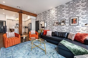 Relax in the living area with a smart TV, stylish seating, and a sleeper sofa for extra guests. Perfect for families or group stays in New Orleans, this inviting space is ideal for movie nights or recharging after a day in the city.