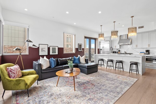 Relax in the living area with a smart TV, stylish seating, and a sleeper sofa for extra guests. Perfect for families or group stays in New Orleans, this inviting space is ideal for movie nights or recharging after a day in the city.
