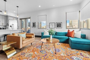 Relax in the living area with a smart TV, stylish seating, and a sleeper sofa for extra guests. Perfect for families or group stays in New Orleans, this inviting space is ideal for movie nights or recharging after a day in the city.