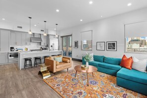 Relax in the living area with a smart TV, stylish seating, and a sleeper sofa for extra guests. Perfect for families or group stays in New Orleans, this inviting space is ideal for movie nights or recharging after a day in the city.