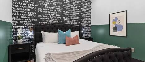 Retreat to the primary bedroom with a plush king bed, walk-in closet, blackout shades, and a smart TV. Designed for comfort and privacy, this suite is perfect for recharging after a day exploring New Orleans.