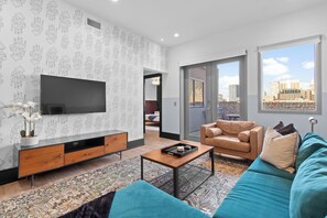 Relax in the living area with a smart TV, stylish seating, and a sleeper sofa for extra guests. Perfect for families or group stays in New Orleans, this inviting space is ideal for movie nights or recharging after a day in the city.