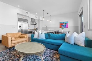 Relax in the living area with a smart TV, stylish seating, and a sleeper sofa for extra guests. Perfect for families or group stays in New Orleans, this inviting space is ideal for movie nights or recharging after a day in the city.