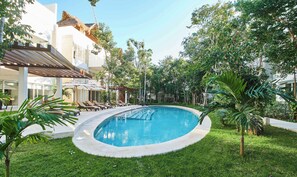 Second Community Pool with Sun Loungers Surrounded with Jungle