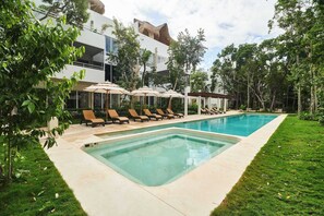Large Community Pool with Jacuzzi & Sun Loungers Surrounded with Jungle