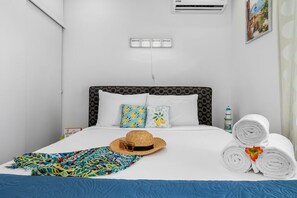 A clean, soft, and comfortable be with air conditioning.