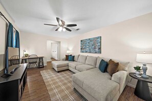 "Relax in style in this cozy living room, where comfort meets modern elegance. Just minutes from El Jardin Beach, this inviting space features plush seating, a sleek TV, and a bright, airy atmosphere. Enjoy year-round comfort with air conditioning and heating, and stay connected with high-speed WiFi. The stylish decor and comfortable setup make it the perfect spot for unwinding after a day of ...