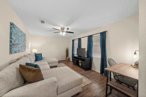 "Step into a cozy and inviting living room in Seabrook, TX, just minutes from El Jardin Beach. This stylish space features comfortable seating and modern decor, perfect for unwinding after a day of exploring. With high-speed WiFi, air conditioning, and heating, you can relax in comfort year-round. Enjoy your favorite shows on the TV and make the most of the laptop-friendly workspace. This livi...