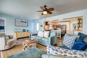 An open layout seamlessly connects the living room to the kitchen, creating a spacious and cohesive area ideal for socializing and entertaining.