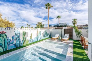 Enjoy our private heated pool, complete with sun loungers, an umbrella, and a unique cactus and succulent mural