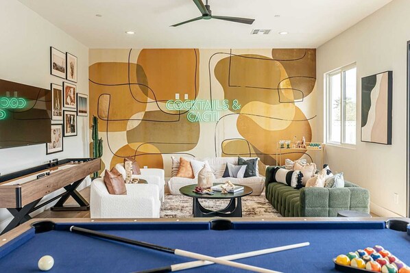 You'll find designer furnishings, a smart TV, shuffleboard, board games, a pool table, a bar cart, jenga, and direct access to the private yard for indoor-outdoor enjoyment