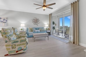 The open living area includes a comfortable sofa and pair of relaxing recliners.