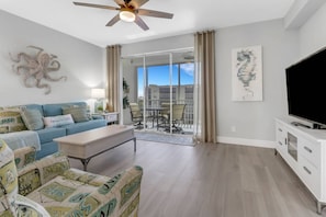 The main living area is highlighted by large sliding glass doors that lead out to the fully screened balcony and view of the western skies.