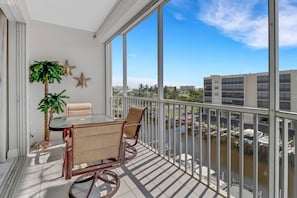 The dining table on the sun-filled balcony is a great spot for overlooking the boat traffic on the canal that leads to the Bay.