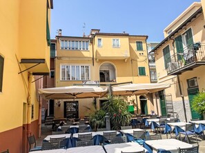 Sky, Property, Furniture, Table, Azure, Chair, Building, Window, Shade, Architecture