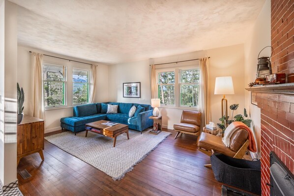 Another angle of the warm and inviting living room, offering ample natural light and a serene atmosphere.