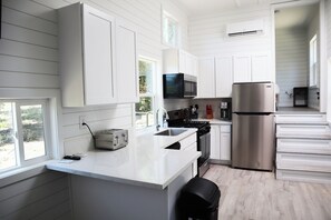 Full kitchen with sink, stove, microwave, dishwasher, refrigerator
