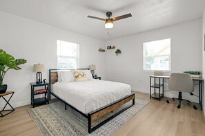 Second bedroom on the main level with queen bed and office area