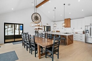 Dining area with large wood table for sitting 10 or more people.